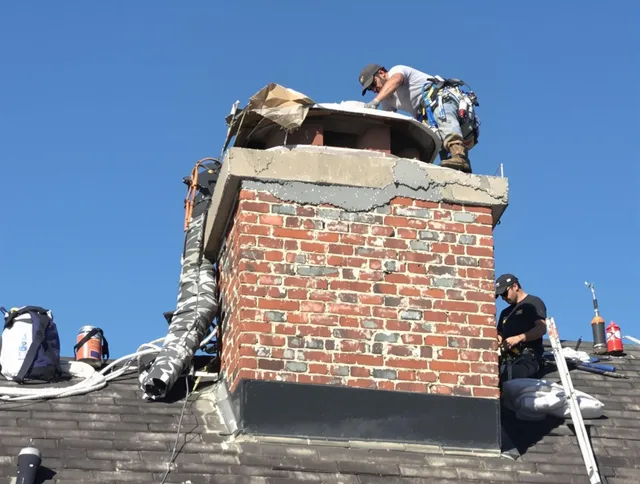 Darien Chimney Sweep installing a custom chimney crown in Darien, CT